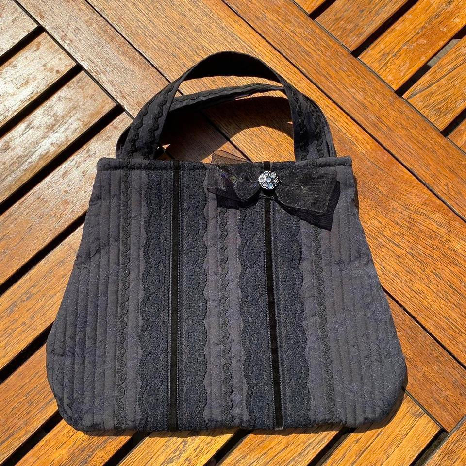 Black lace fabric handbag