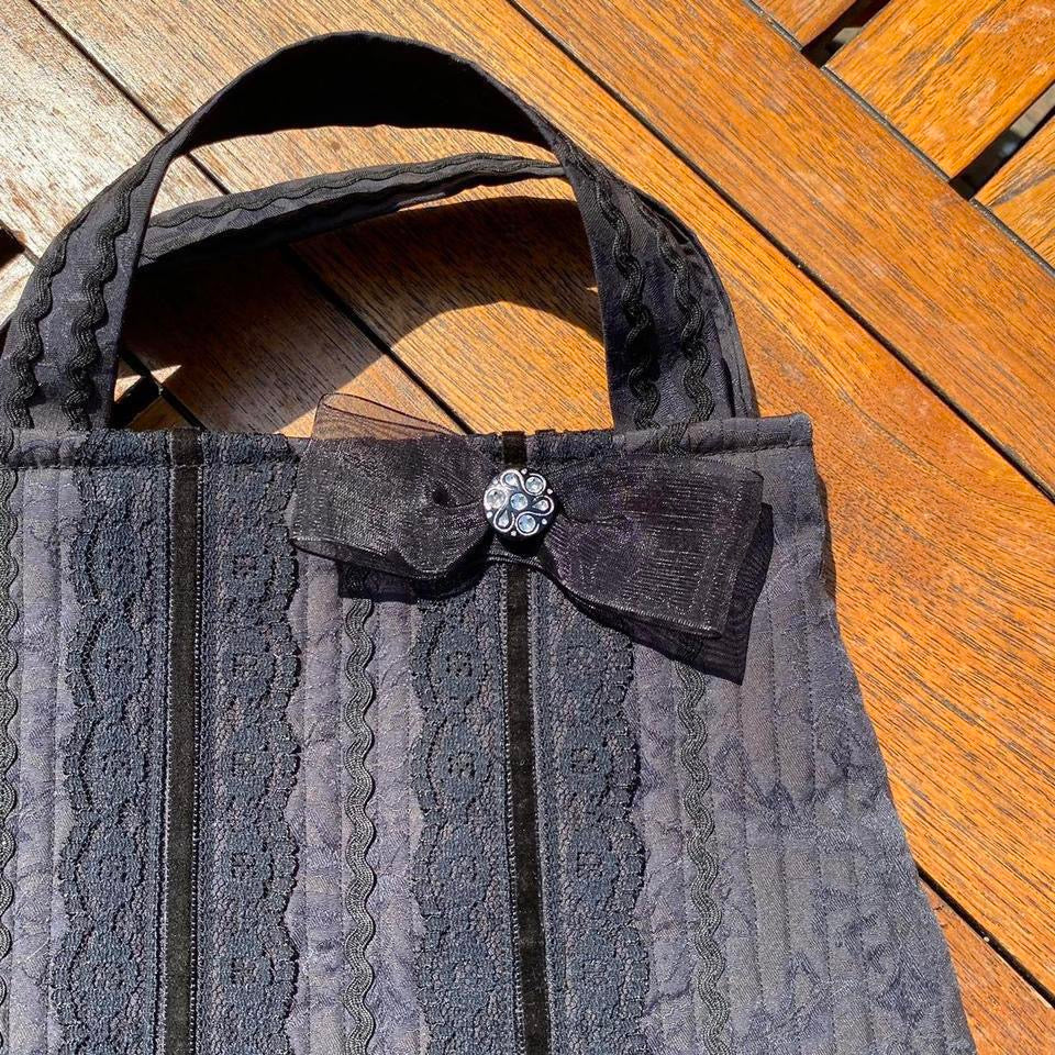 Black lace fabric handbag